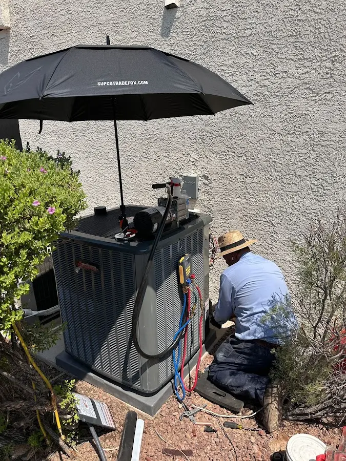 HVAC technician performing outdoor AC maintenance in Carrollton