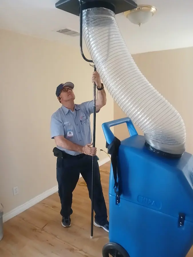 Furnace Tune-Up technician using HEPA equipment in Carrollton